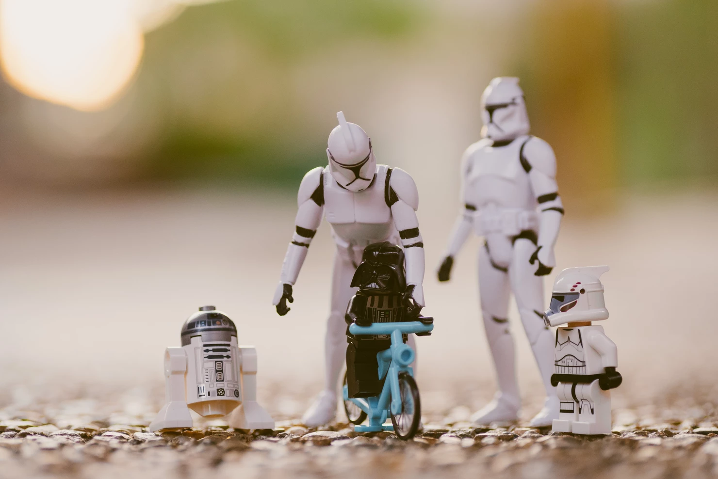 Model Stormtroopers teach a model Darth Vader how to ride a bike